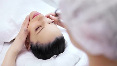 Woman Receiving Facial Massage in Beauty Clinic