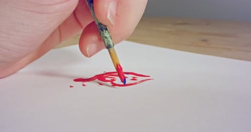 Hand Painting with Brush and Red and Blue Paint