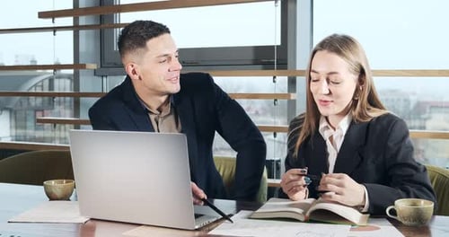Man and a Woman Discussing Work in the Brightly Lit Modern Office. Concerned Male and Female Working