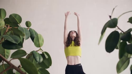 The Girl Stands in One of the Positions of the Asana. Yoga Exercises Makes a Beautiful Young Girl in