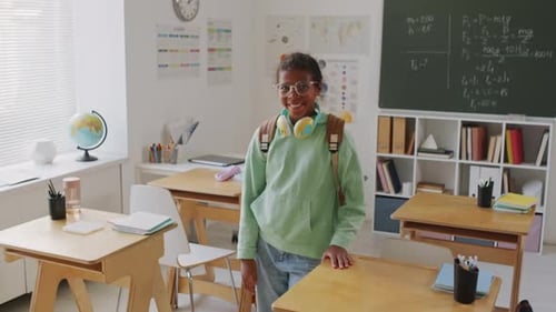 Smiling Student Poses in Bright Classroom