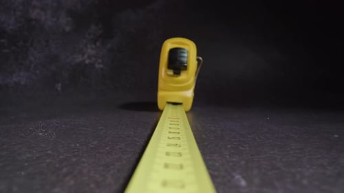 Motion Above Retractable Ruler with Plastic Casing on Table