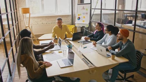 Team Meeting Around Table With Laptops