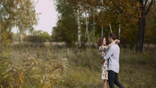 Young Couple Walking on a Meadow