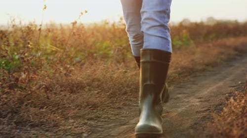 Man in Rubber Boots Walking on the Country Road, Close-up