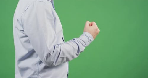 Side view of a man clenching his fist
