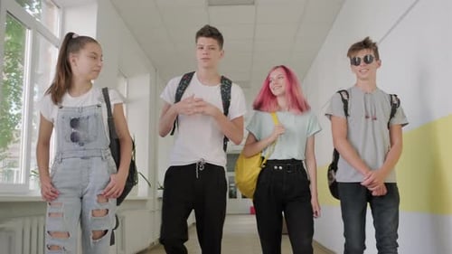 Group of Teenage Students Walking Together Along School Corridor, Schoolchildren Smiling and Talking