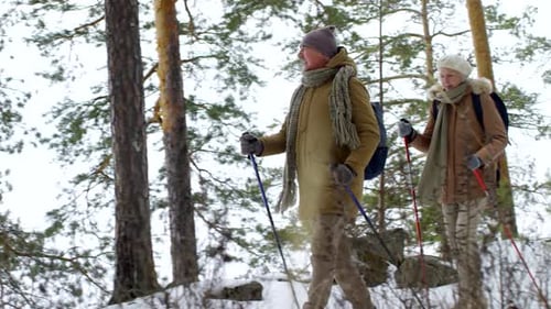 Senior Caucasian Couple Enjoying Nature Walk in Snow