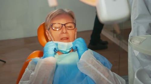 Woman Getting Dental Work Performed by Dentist