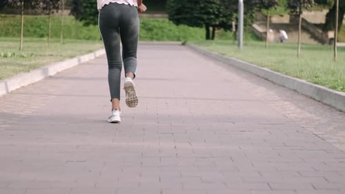 Young Active African American Woman Jogging in Park To Keep Healthy