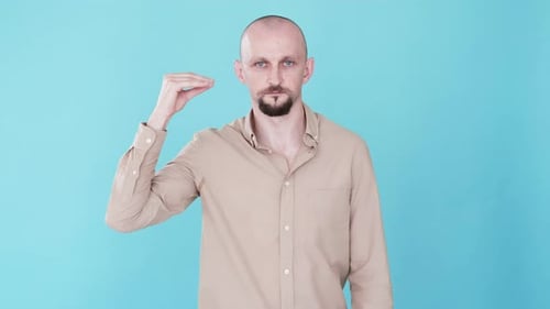 Man Gesturing to Side of Face in Studio
