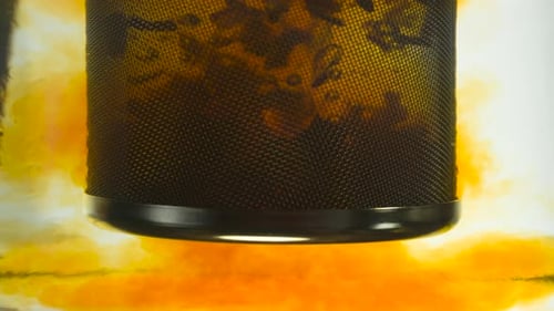 Mesh Cylinder Infusing Loose-Leaf Tea in Hot Water