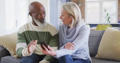 Loving Couple Enjoying Cell Phone at Home