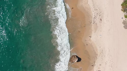 tropical summer seascape, green turquoise water breaking on sandy beach. Bird eyes view