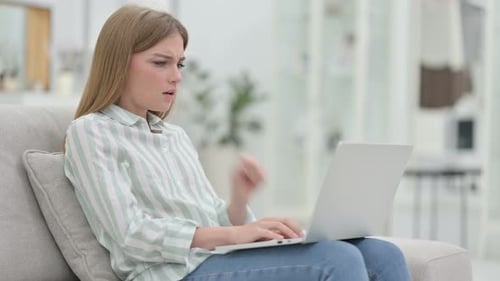 Woman Coughing While Using Laptop at Home