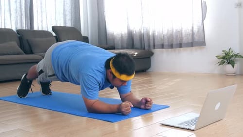 Young Adult Male Doing Plank Exercise at Home