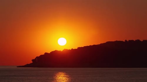 Golden Sunset over Ocean and Island Silhouette