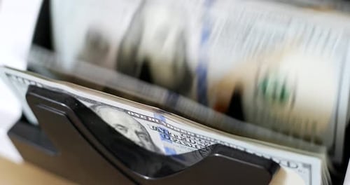 America banknote on automatic counting machine