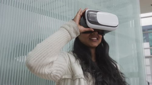 Young Woman Using Virtual Reality Headset Indoors
