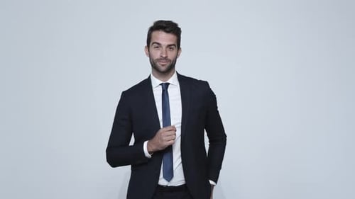 Man in Navy Suit Adjusts Cuffs