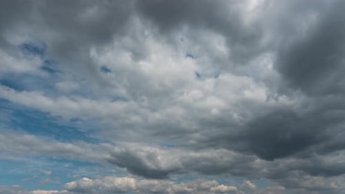 Dramatic Storm Clouds Time-Lapse Over Light Blue Sky