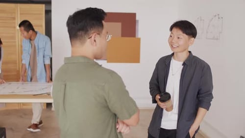 Asian Coworkers Chatting in Architects Office
