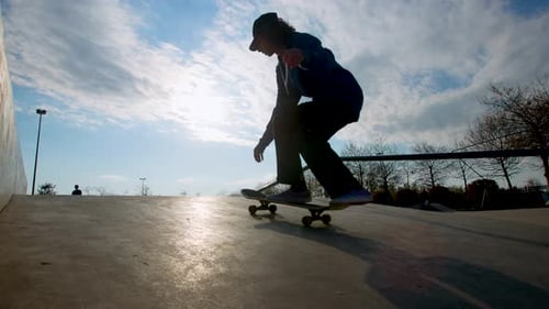 Silhouette of Skateboarder Performing Flip Trick in Skatepark