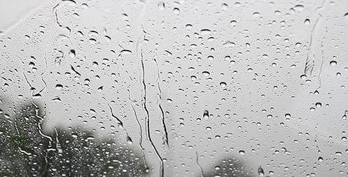 Rain Streaks Running Down a Window Pane