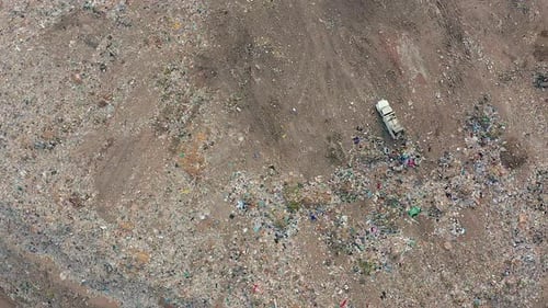 The Bulldozer Compacts the Garbage on the Landfill. Wastes of Human Life. Aerial View