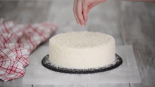 Sprinkling White Shavings on Cake in Home Kitchen