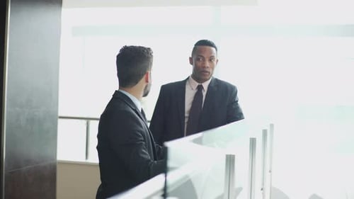 Business professionals looking at office building interior