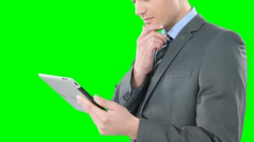Man in Suit Uses Tablet on Green Screen