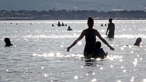 Mother And Son Dancing In The Sea