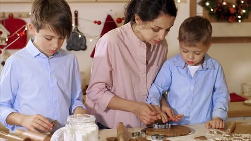 Family Baking Gingerbread Cookies in Kitchen