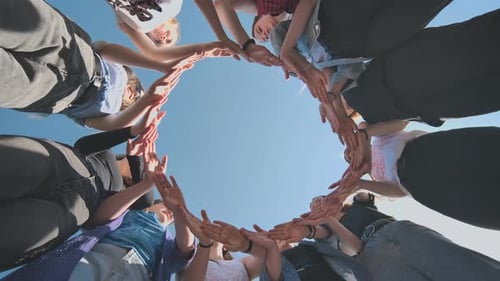 A Group of Girls Makes a Circle From Their Palms