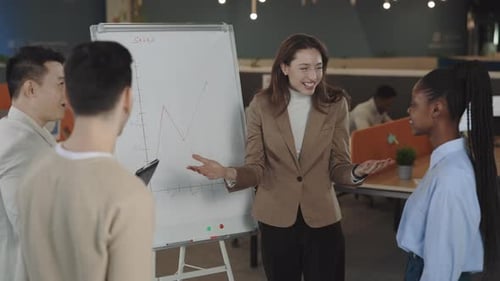 Colleagues Applaud Sales Presentation in Modern Office