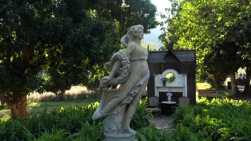Antique Stone Female Statue in Garden in Sunlight