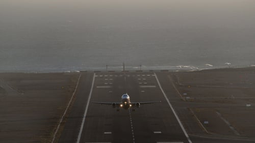 Airplane Taking Off from Runway Near Ocean