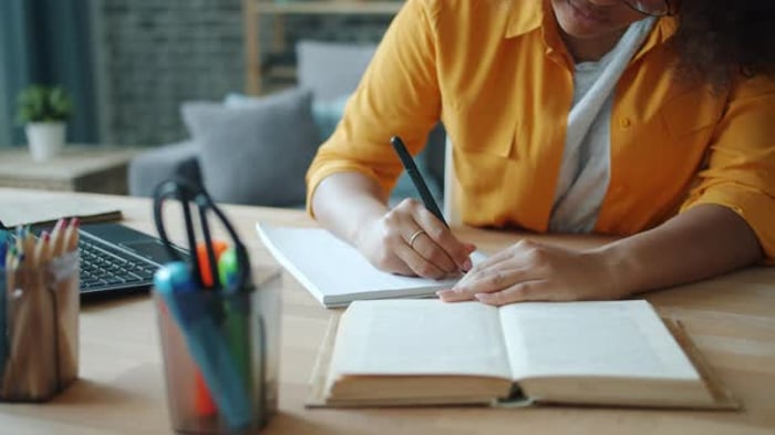 Person Writes in Notebook with Book, People Stock Footage ft. studying ...
