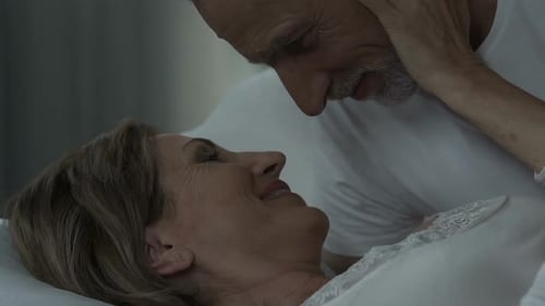 Loving Senior Couple Share Affectionate Moment in Bed