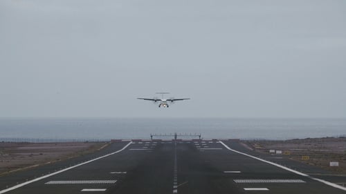 Airplane Approaching Airport Runway for Landing on Overcast Day