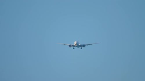 Passenger Plane Approaching in Blue Sky