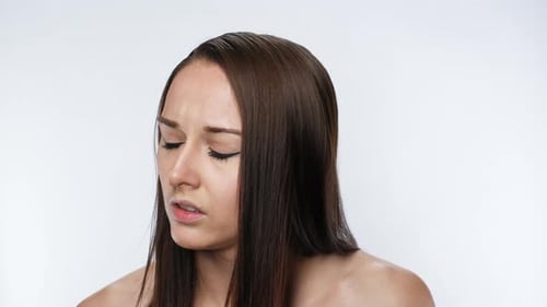 Woman with concerned expression looking at camera