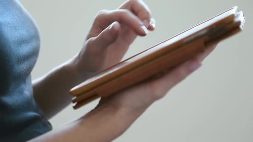 Close Up of Female Hands Using Tablet Computer Browsing Internet Working Online Researching