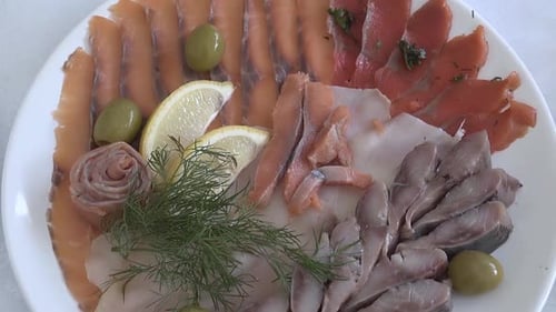 Assortment of Sliced Fish with Olives and Lemon