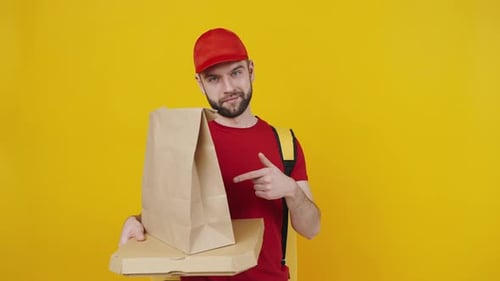Friendly Delivery Guy Holding Food Package and Pizza