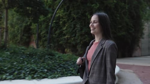 Confident Businesswoman in Suit Walking in City Street