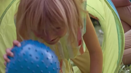 Girl Crawling through Play Tunnel