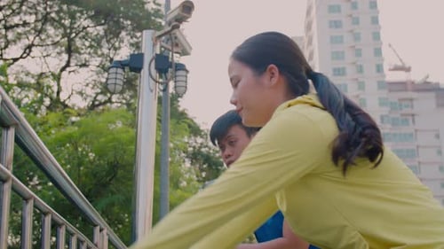 Athletic Young Adults Stretching Together in an Urban Park