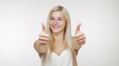 Woman Smiling and Giving Double Thumbs Up